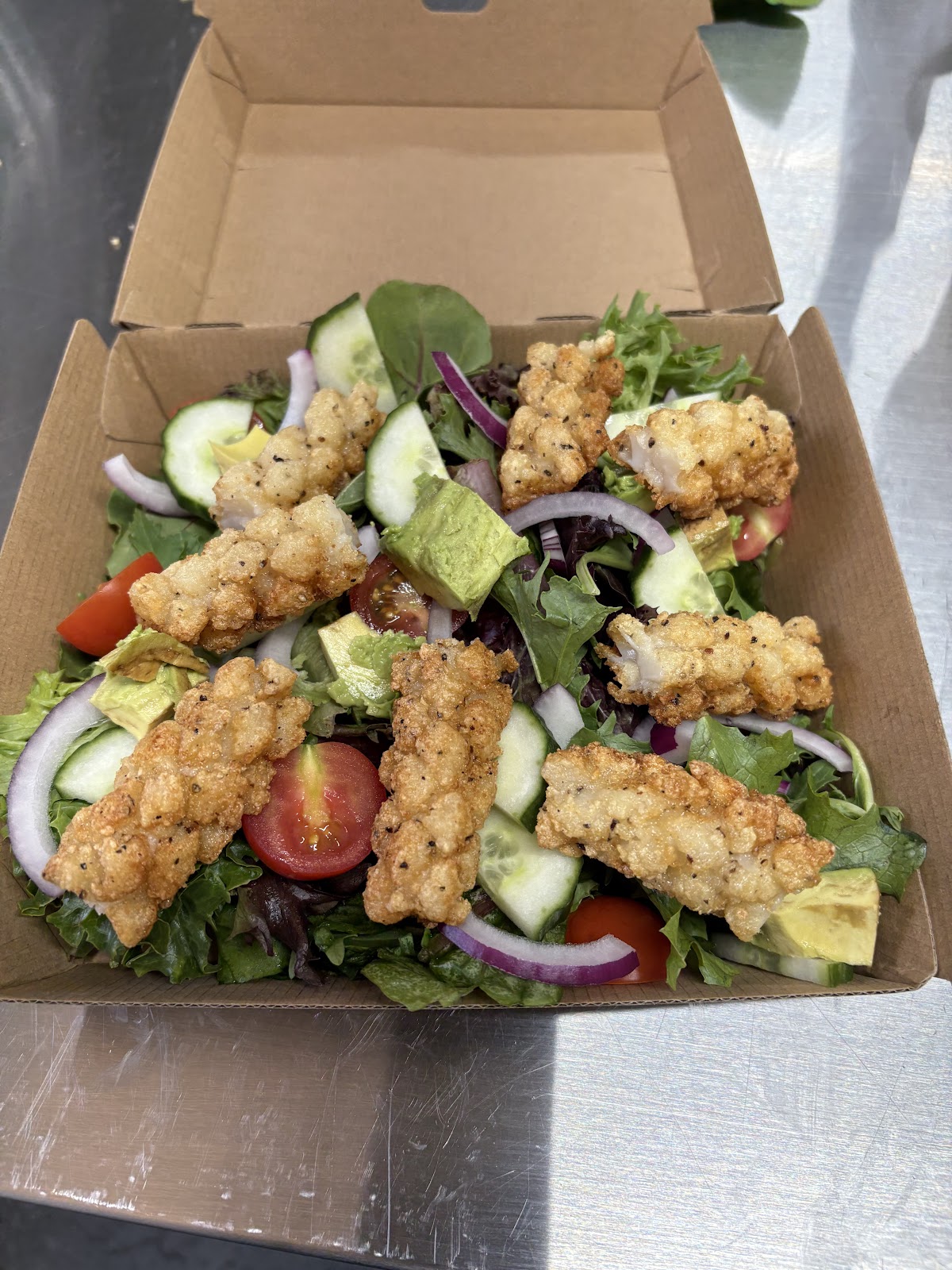 Crumbed chicken salad packed in a takeaway box