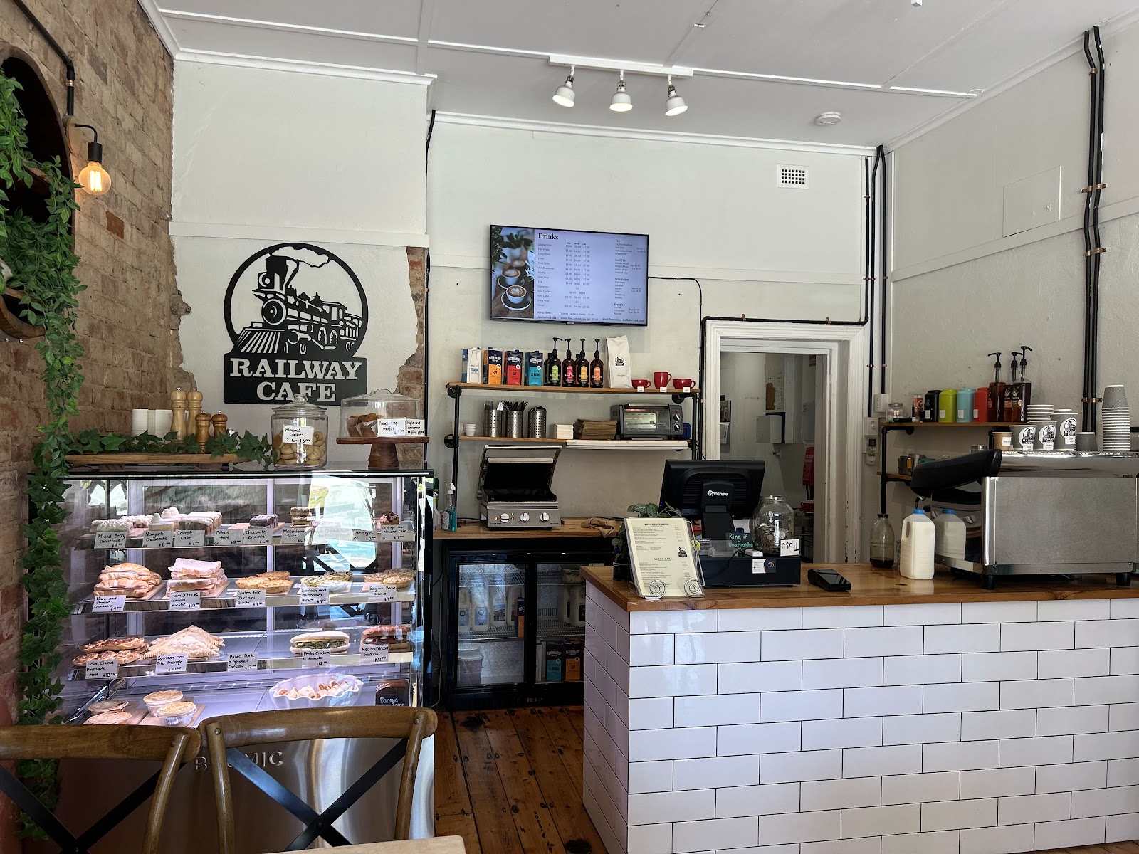 The Railway Cafe counter with white subway tiles, the coffee machine and the cake cabinet